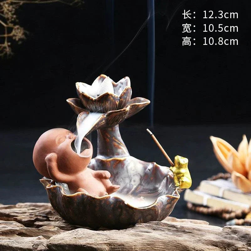Backflow Purple Sand ceramic incense burner with lotus and meditating monk design releasing smoke cascade
