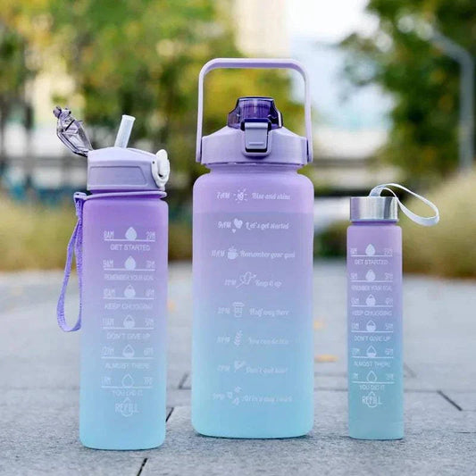 Set of three motivational water bottles with time markers in purple and blue gradient, each featuring a straw or sport cap and inspirational quotes for tracking daily water intake.