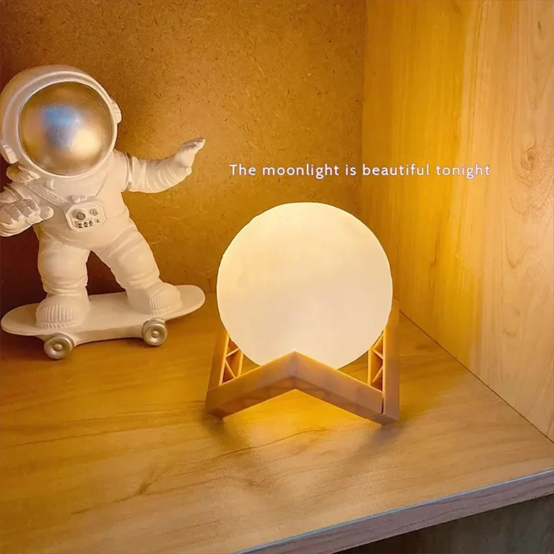 Cosmic Moon LED Book Light glowing on wooden stand next to astronaut figurine on shelf