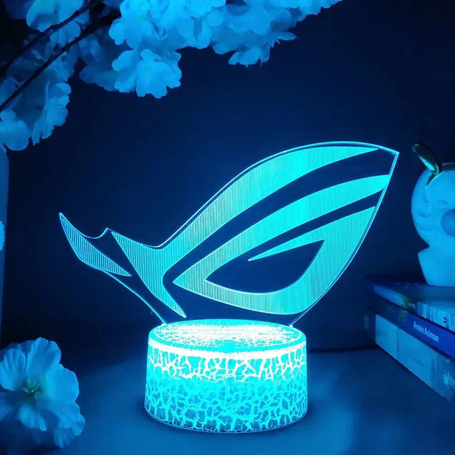 ROG 3D LED lamp with blue light, black crack-pattern lamp base, engraved acrylic panel, gaming night light with color-changing LED illumination.