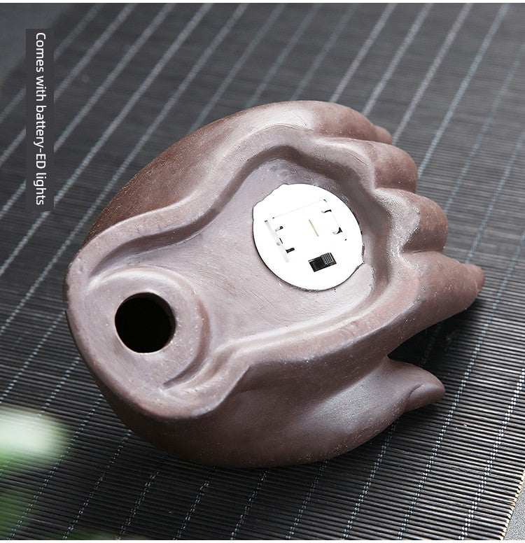 Backflow purple sand ceramic incense burner shaped like Buddha's hand with battery-powered LED lights