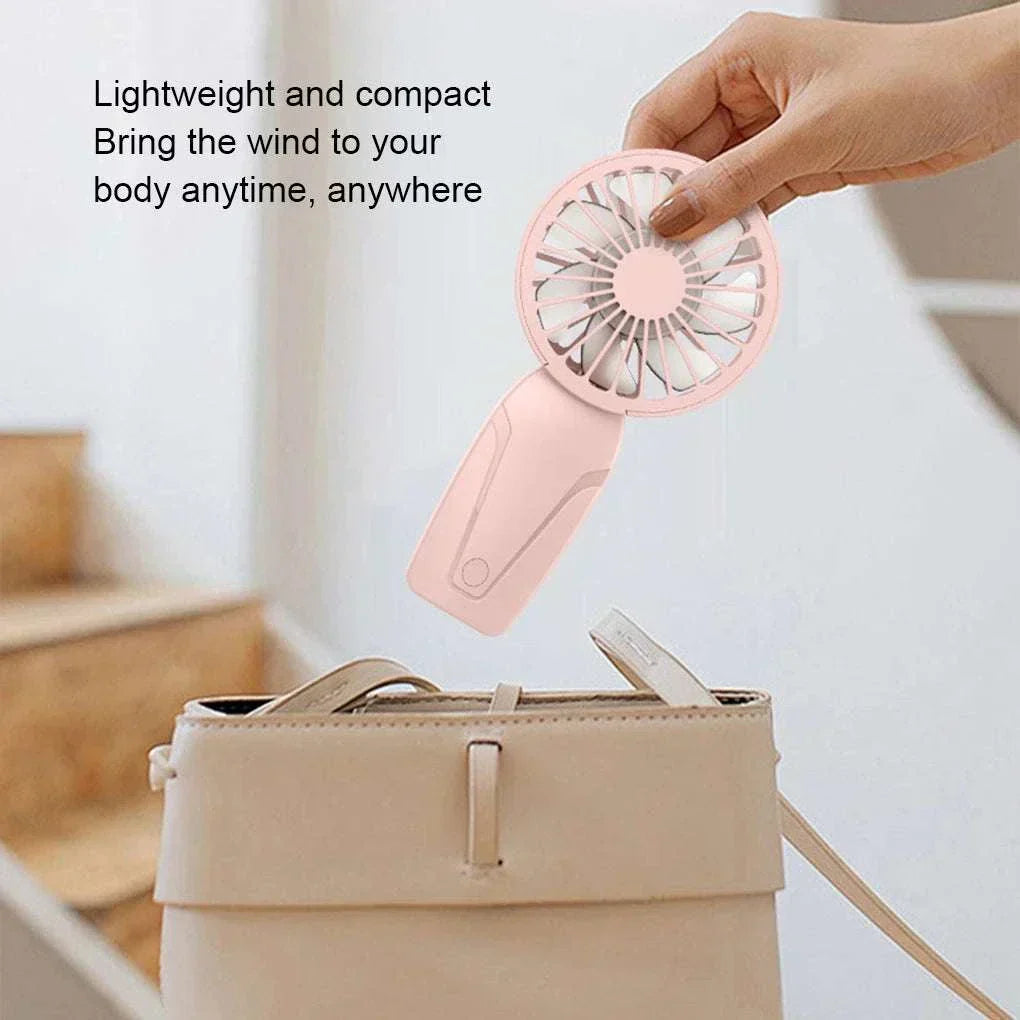 Cute portable handheld USB rechargeable fan in pink, lightweight and compact for on-the-go cooling.