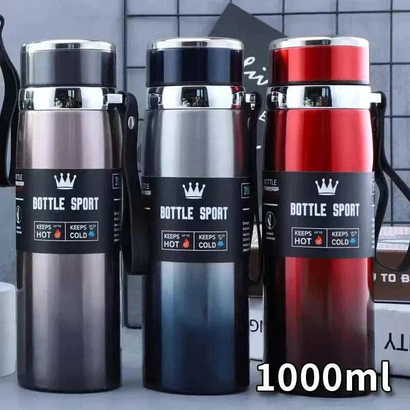 Set of three 1L stainless steel thermal water bottles in gray, black, and red with insulated design to keep drinks hot or cold.