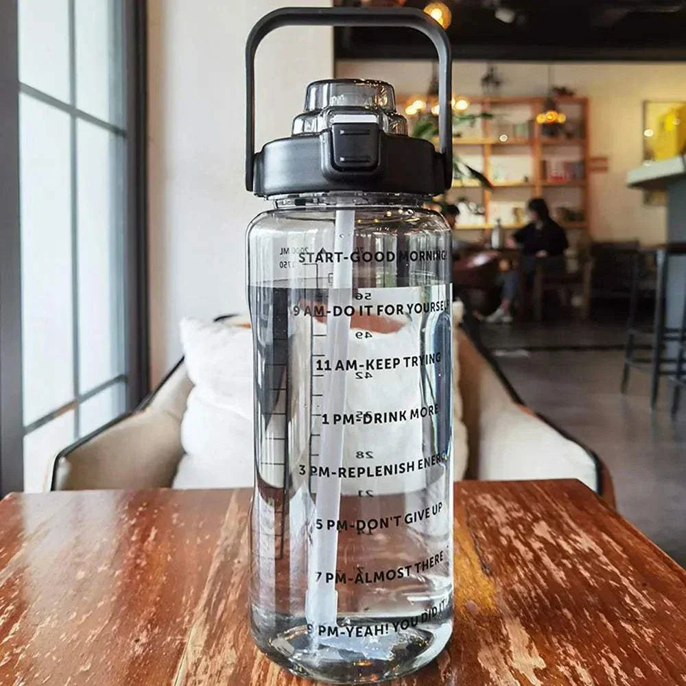 Clear sports water bottle with motivational quotes and time markers, reusable with straw lid, perfect for tracking daily hydration.