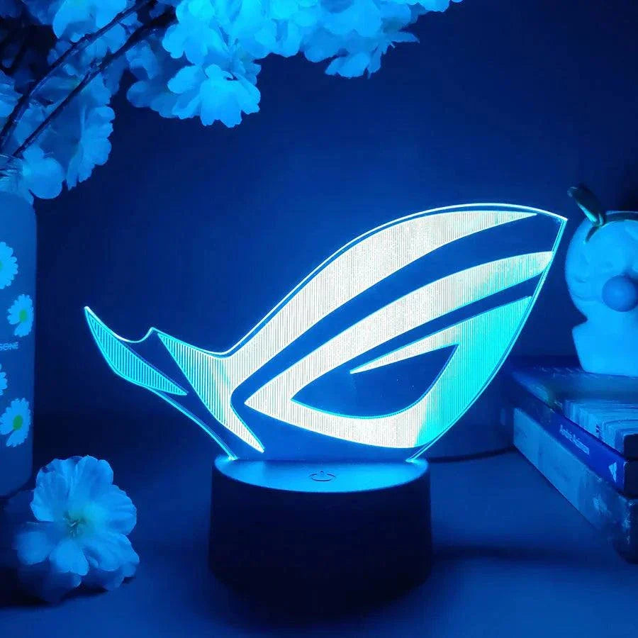 ROG 3D LED Lamp with black base glowing blue in gaming setup decor