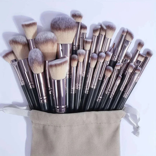 MAANGE 30-piece professional makeup brush set with nylon bristles and black handles in a beige drawstring bag