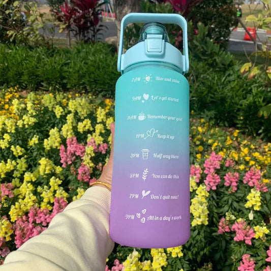 Reusable sports water bottle with motivational quotes and time markers, gradient blue to purple design, straw lid, eco-friendly plastic.