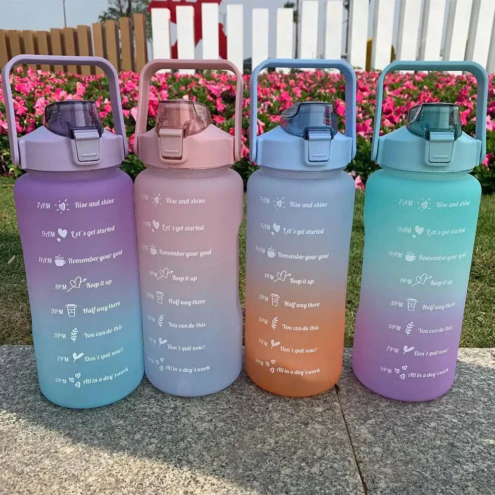 Colorful sports water bottles with motivational quotes and time markers, featuring leakproof lids and straw caps for easy drinking.