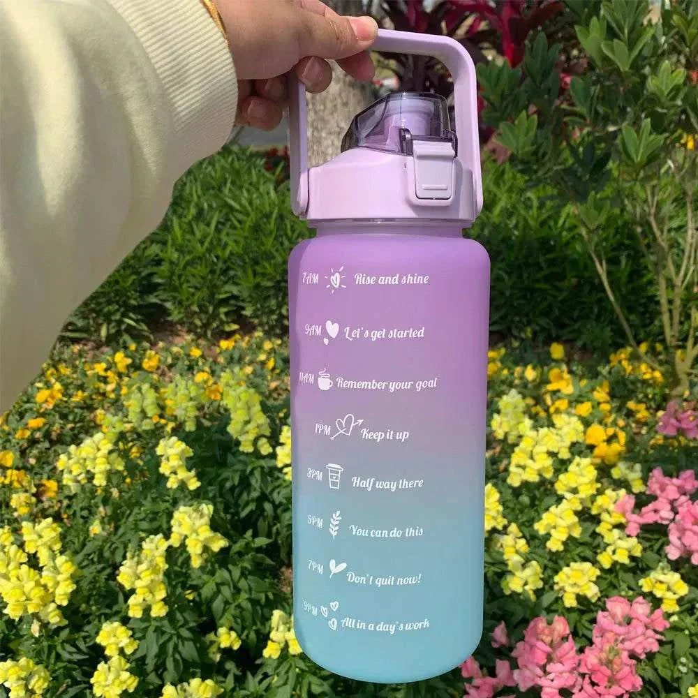 Purple to blue gradient water bottle with motivational quotes and time markers, sports design with straw and leakproof lid.