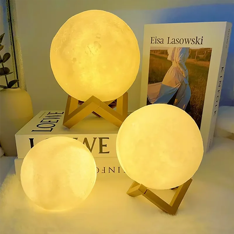 Cosmic Moon LED Book Light with warm glow on wooden stands, perfect for child bedroom decor or birthday gift.