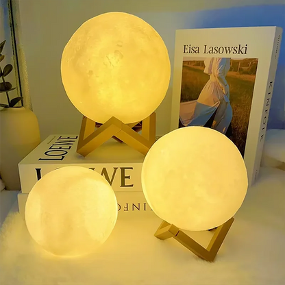 Cosmic Moon LED Book Light with warm glow on wooden stands, perfect for child bedroom decor or birthday gift.