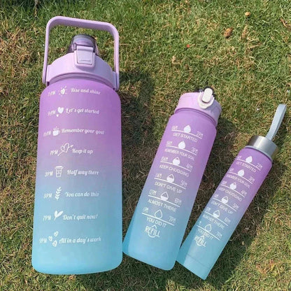 Purple and blue gradient water bottles with motivational quotes and time markers, reusable plastic sports bottles with straw and leakproof lids, eco-friendly and BPA-free.