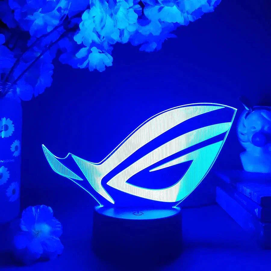 ROG 3D LED Lamp with black base glowing in blue light for gaming setup decor
