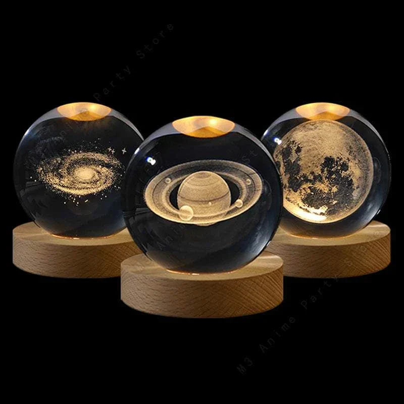 Crystal Ball Moon-Galaxy-Saturn-Solar System LED-Set of three crystal ball LED night lights featuring 3D laser engravings of the moon, galaxy, and Saturn on wooden bases.
