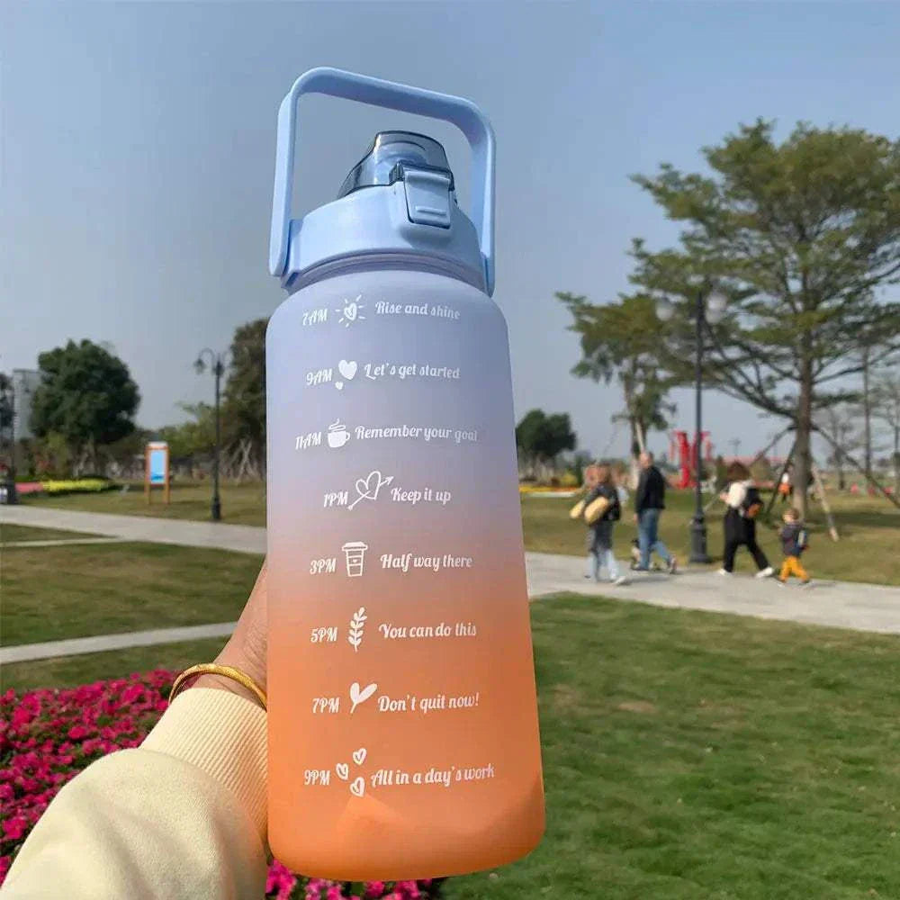 Reusable sports water bottle with time markers and motivational quotes in a gradient pastel color, featuring a straw and leakproof lid.