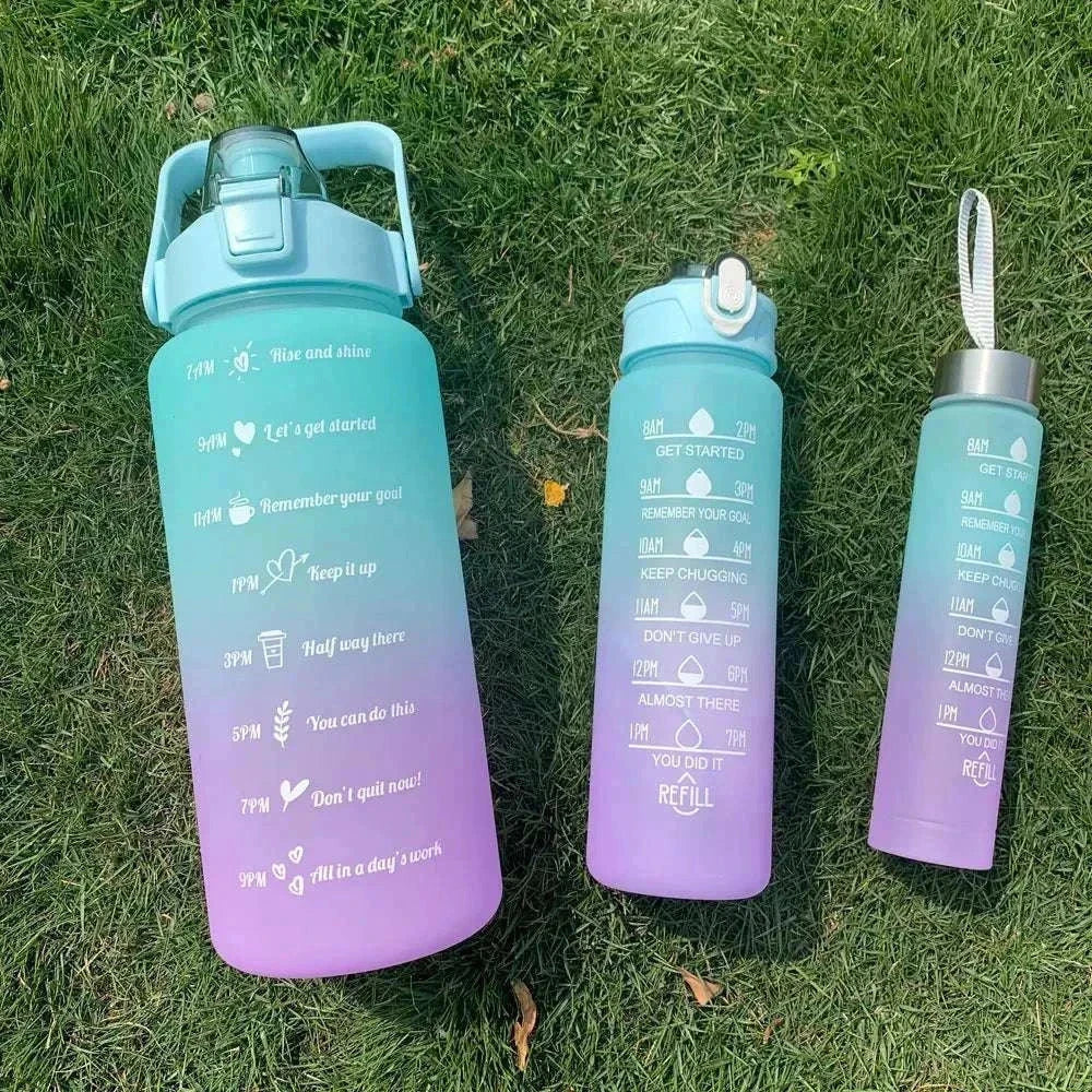 Set of purple and blue gradient water bottles with motivational quotes and time markers for hydration tracking
