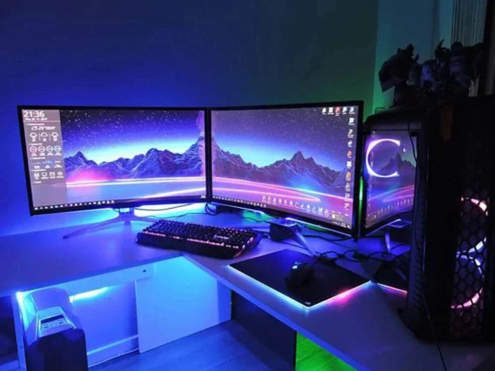 LED Light StripUSB LED strip lights 5050 installed under dual monitors and desk, glowing in vibrant blue and purple shades.