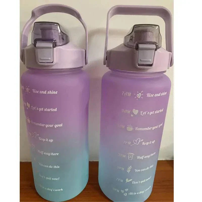 Purple and blue water bottles with motivational quotes and time markers, featuring leakproof lids and straws for easy drinking.