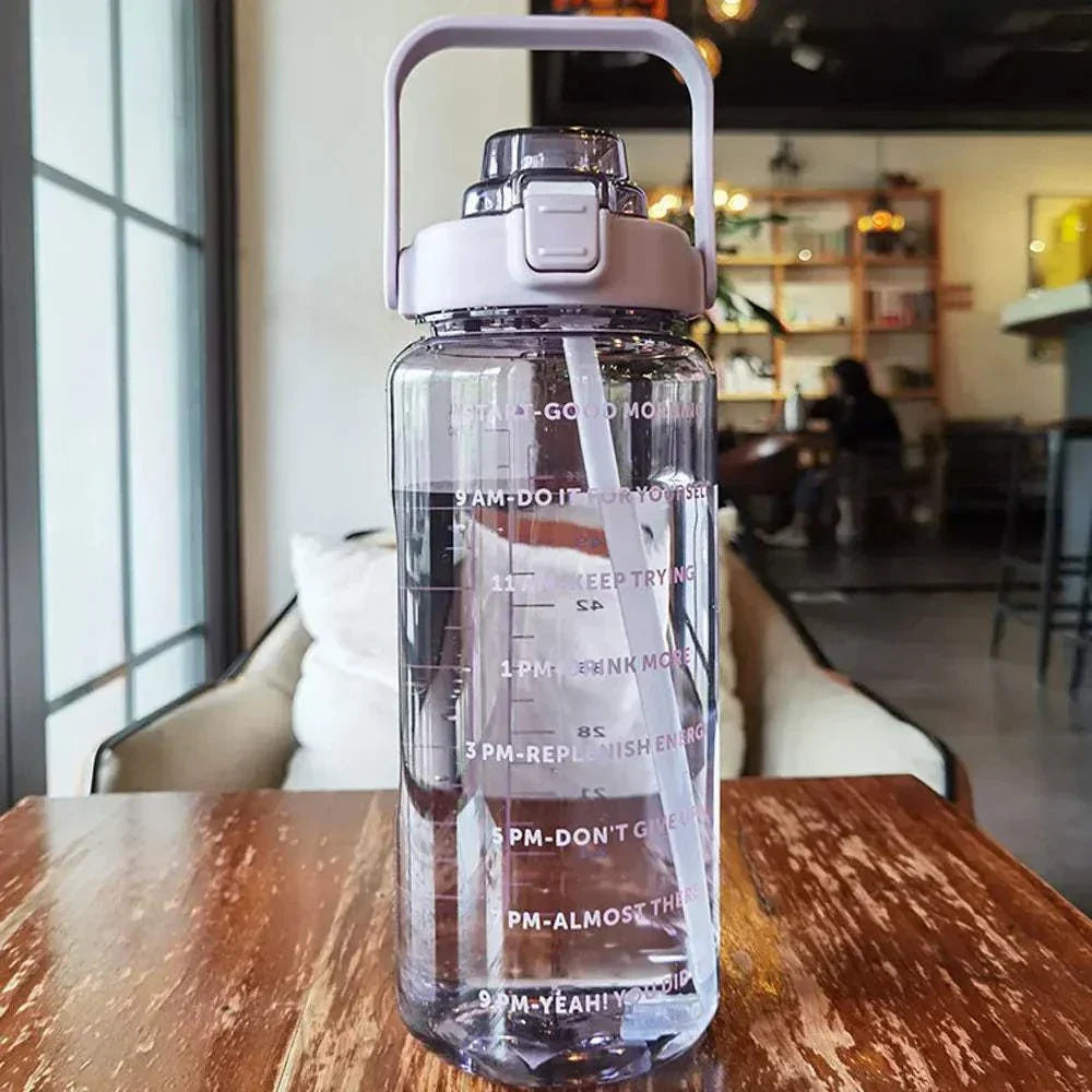 Clear sports water bottle with motivational quotes and time markers, featuring a straw and leakproof lid, ideal for tracking daily hydration.