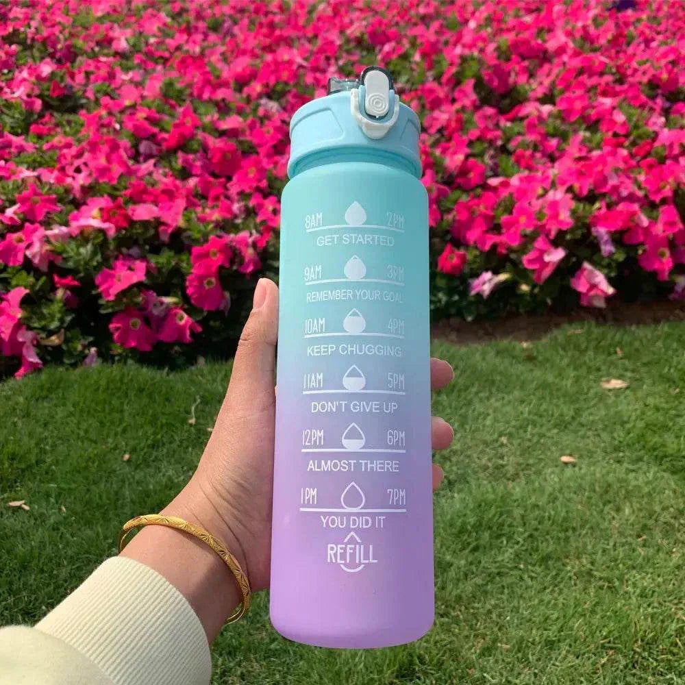 Colorful gradient sports water bottle with motivational quotes and time markers for daily hydration tracking.