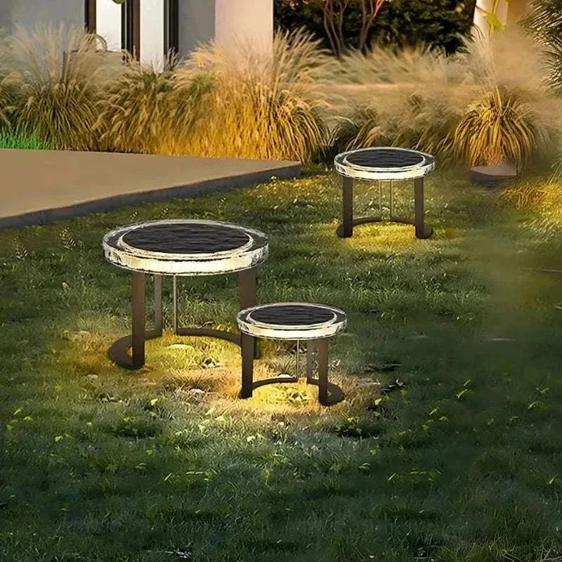 Solar powered outdoor garden tables with waterproof LED lights glowing at night on lawn