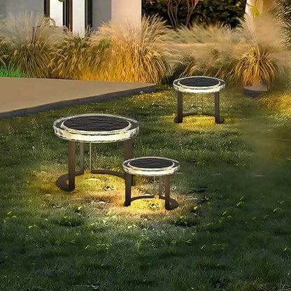 Solar powered outdoor garden tables with waterproof LED lights glowing at night on lawn