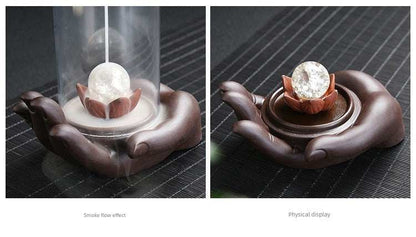Backflow purple sand incense burner with glass orb on lotus held by ceramic Buddha hand decoration